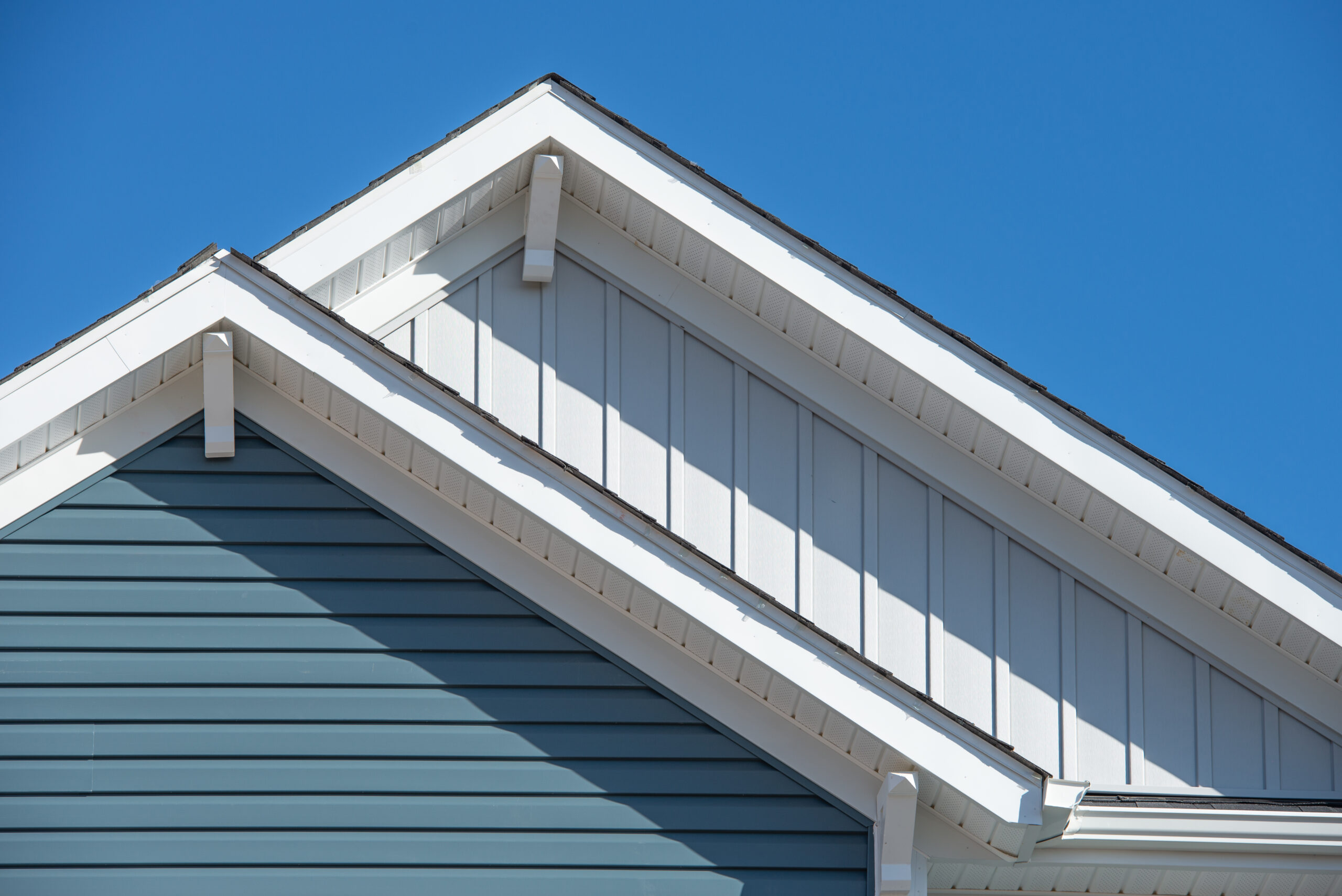 Double gable, with white decorative corbel, bracket, brace on a triangle gable roof