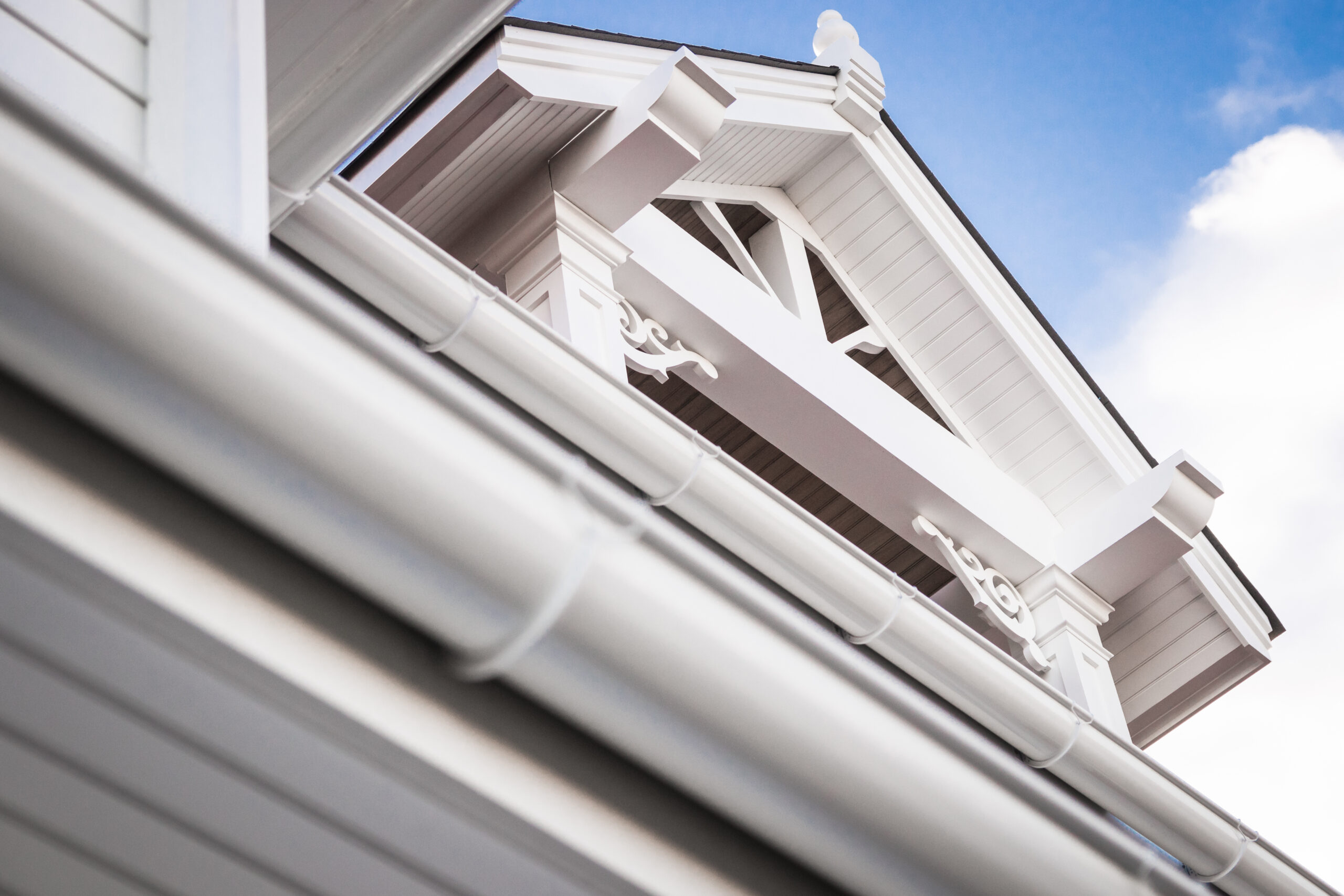 Gable roof, millwork, and trim of modern home exterior.