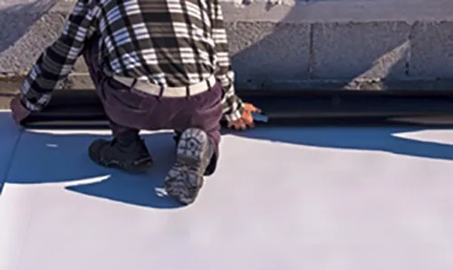 roofer installing Single Ply roofing membrane