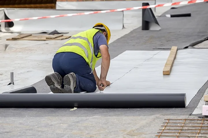 roofer installing Thermoplastic roofing membrane