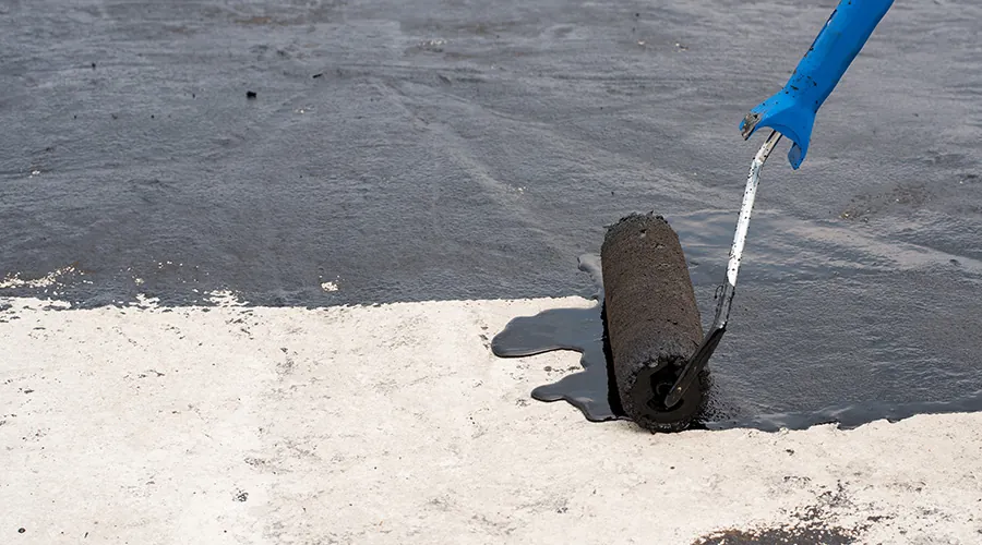 Priming the surface of a roof with a roller