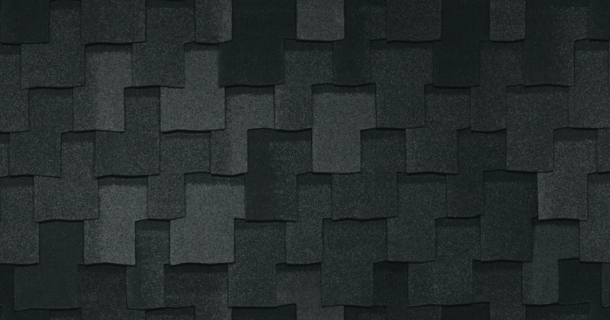 Close-up of overlapping dark gray roofing shingles arranged in a staggered pattern.