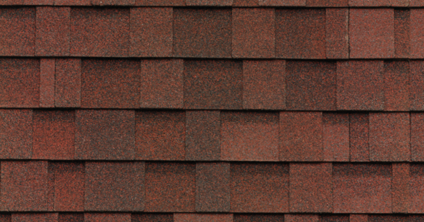 Red asphalt roof shingles arranged in a pattern.