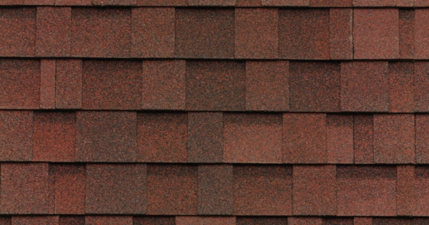 Red asphalt roof shingles arranged in a pattern.