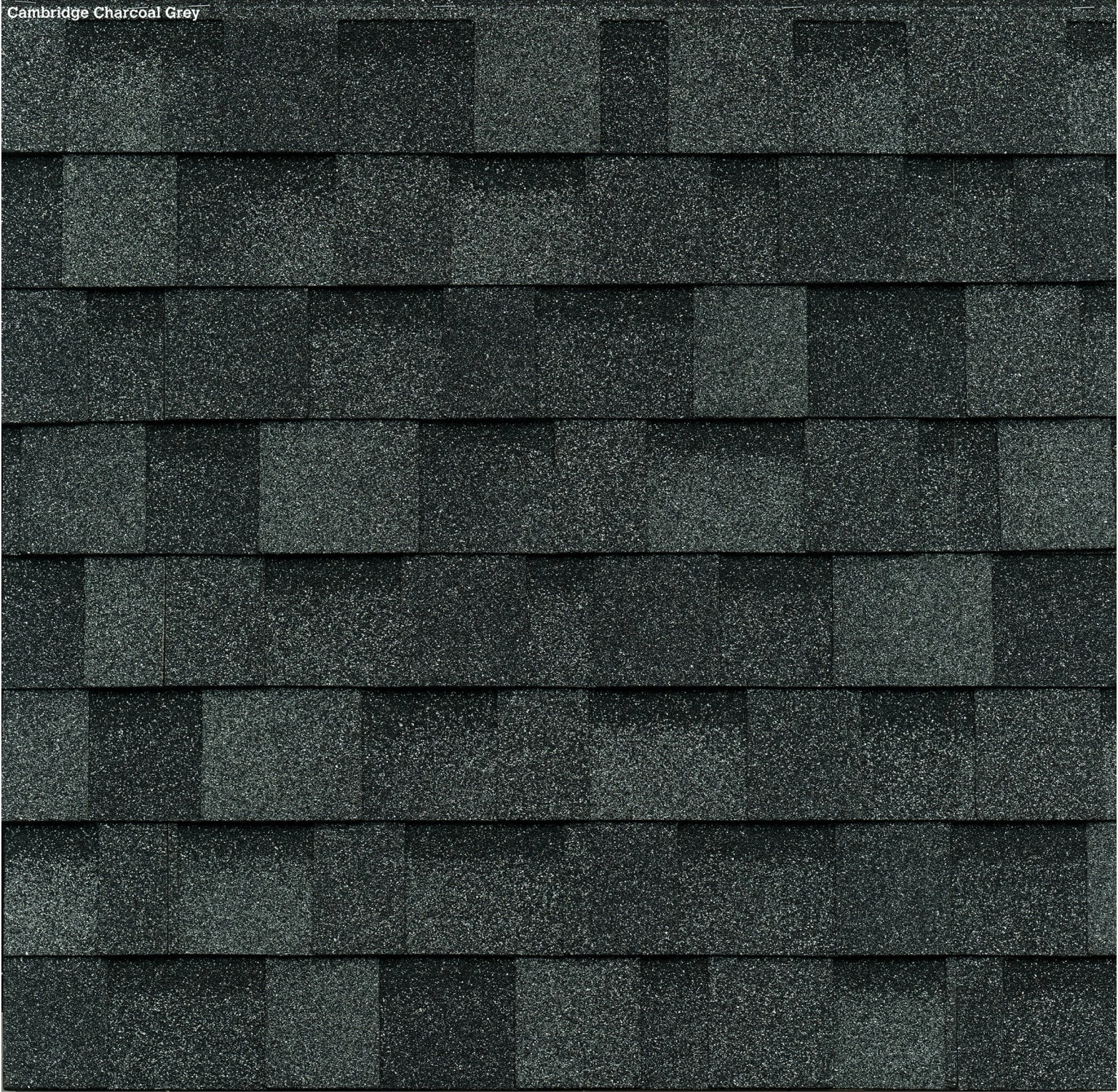 Charcoal grey roof shingles, reminiscent of the Cambridge style, are arranged in horizontal rows with a textured, speckled surface.