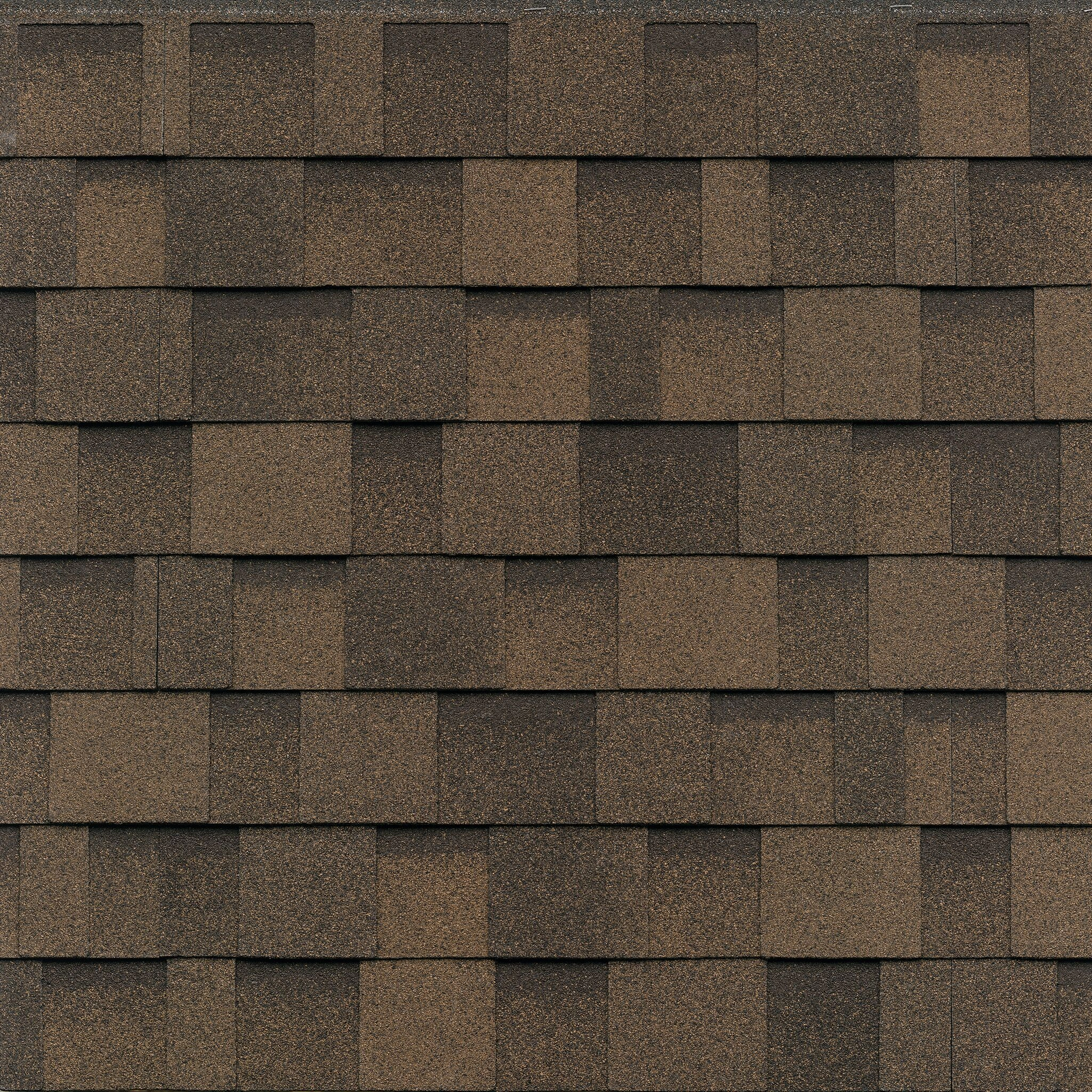 Close-up of brown asphalt roof shingles in a staggered pattern, showcasing the rich tones of Dual Brown.