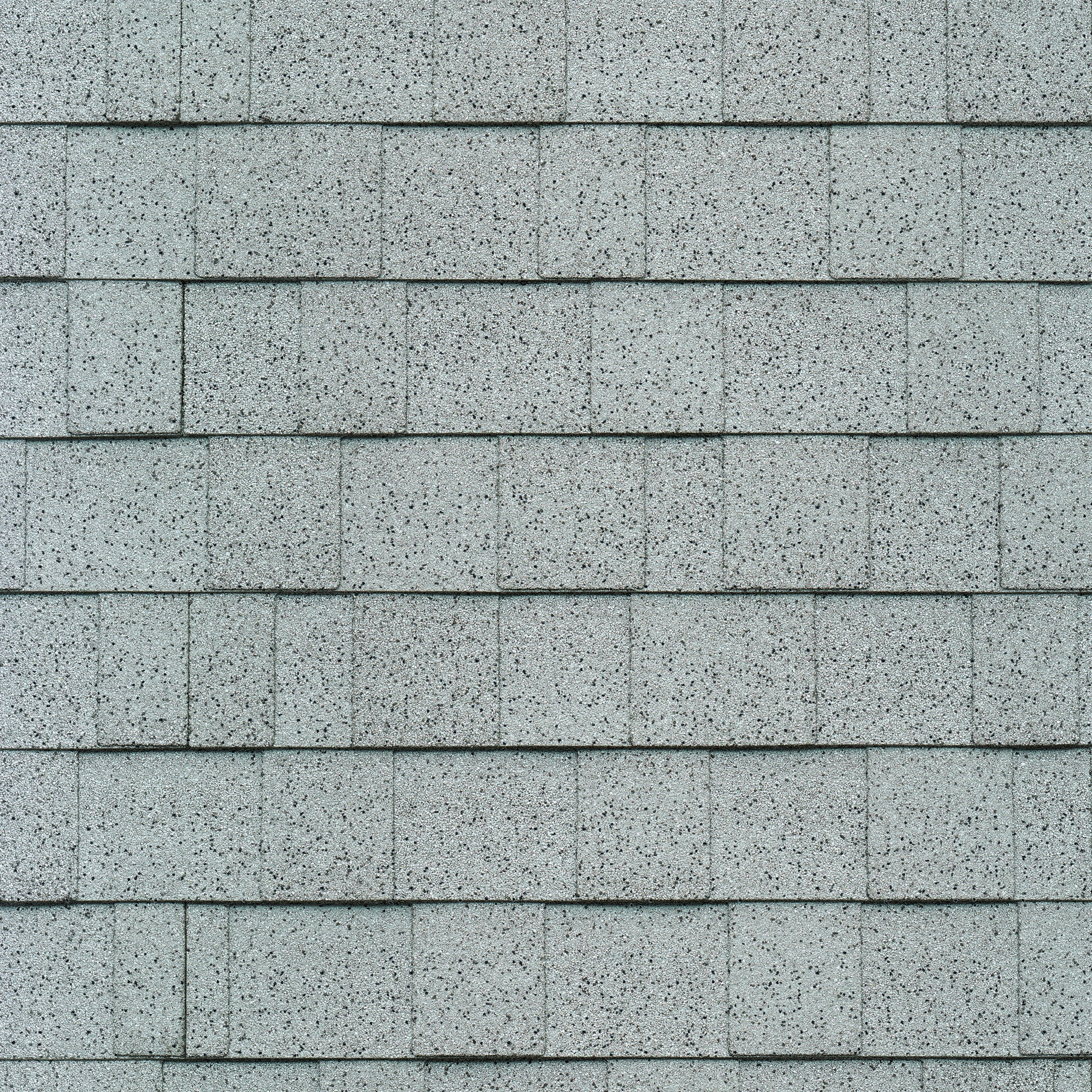 Close-up of Cambridge asphalt roof shingles in a neat, overlapping pattern with hints of Dove White accentuating the gray.