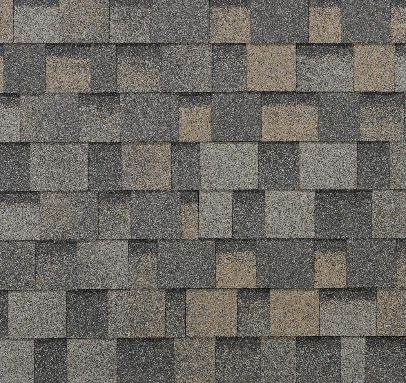 Close-up of a Dynasty asphalt shingle roof featuring a mix of gray and brown rectangular shingles arranged in a staggered pattern.