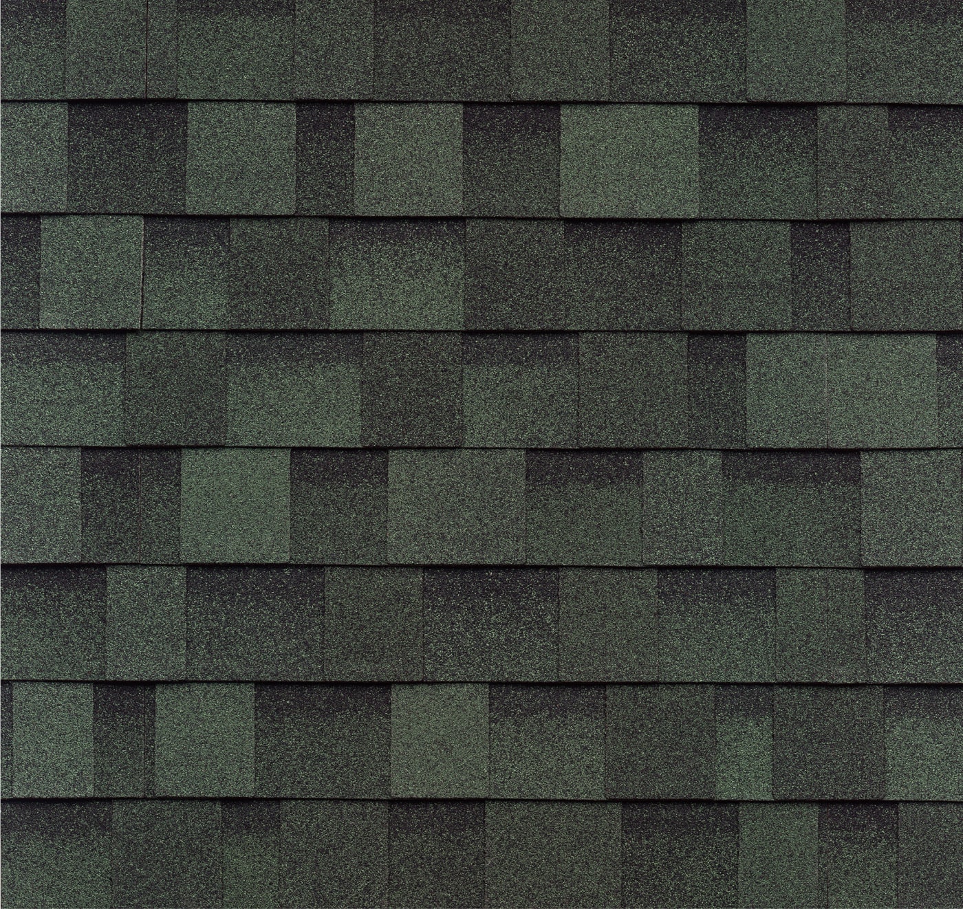 Close-up of emerald green asphalt roof shingles arranged in a layered, overlapping pattern that exudes a sense of dynasty with its timeless elegance.