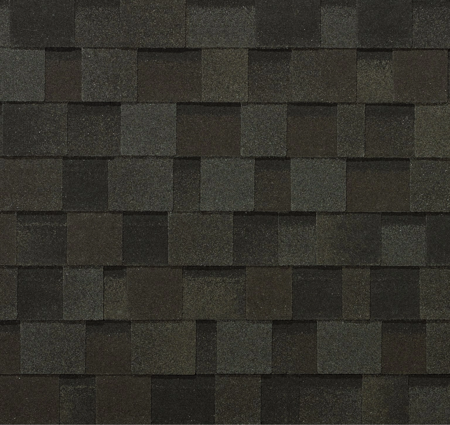 Close-up of dark gray asphalt roof shingles, arranged in an overlapping pattern reminiscent of a Nordic glacier landscape.