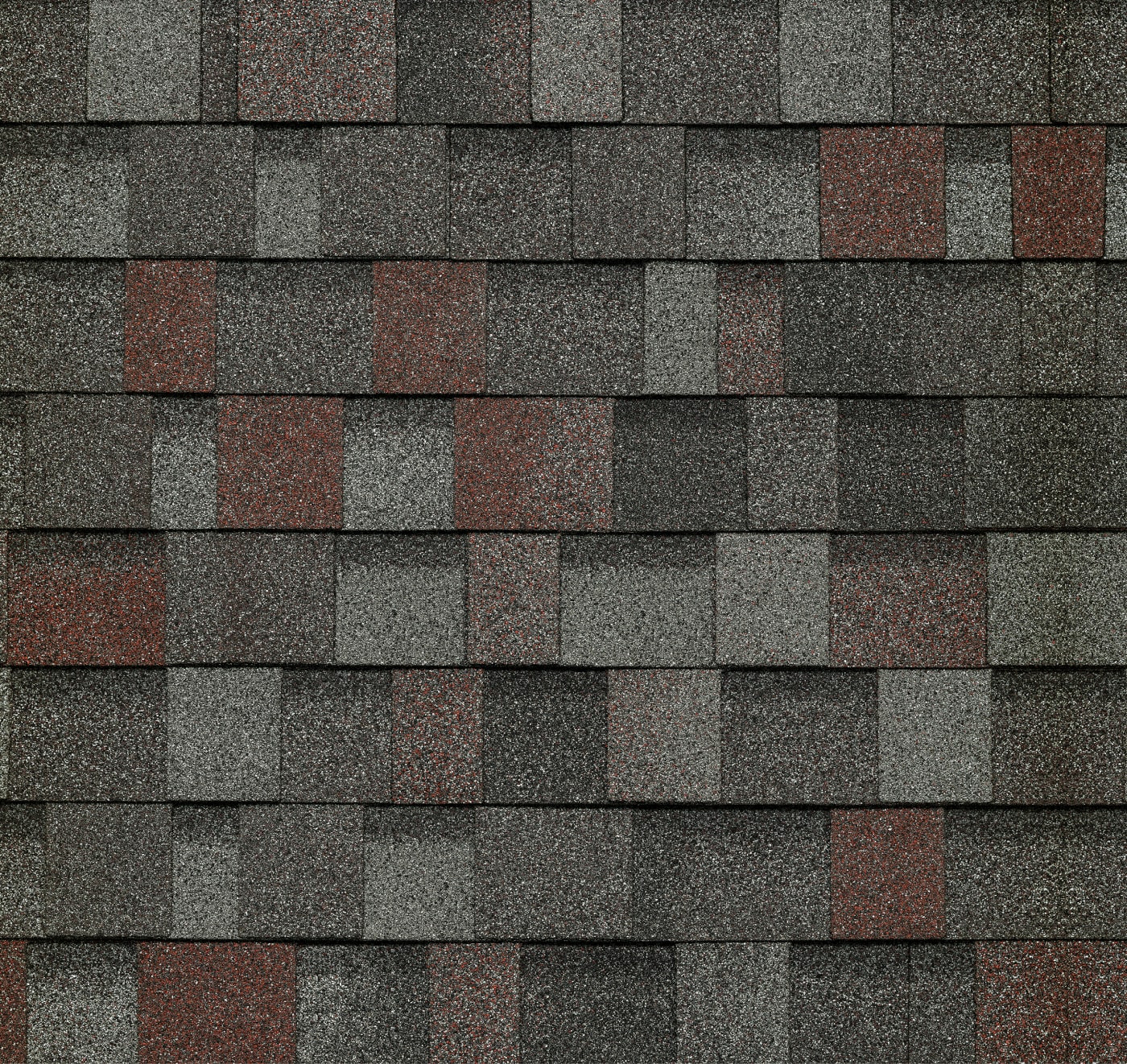 Close-up of a roof featuring alternating gray and red asphalt shingles, reminiscent of the elegant patterns found in a slate dynasty design.