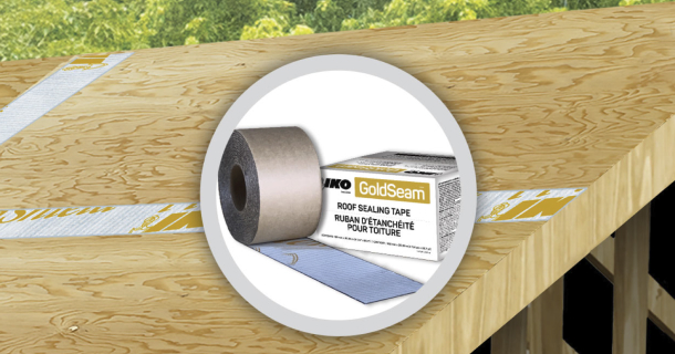 A roll of Gold Seam™ black and white tape partially unrolled on plywood flooring.