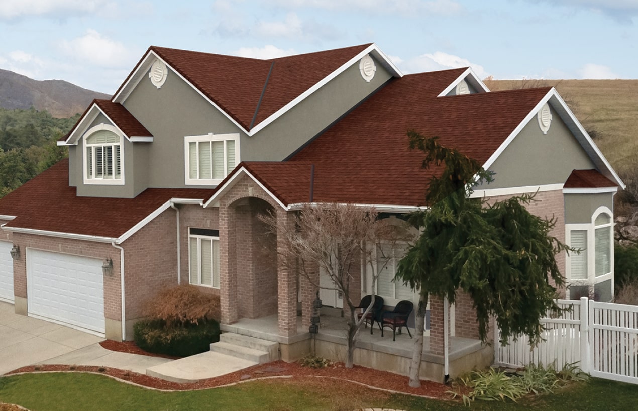 This two-story brick house showcases a touch of dynasty with its elegant white siding, black shutters, and shingled roof. The striking red front door and bay window invite you into a beautifully landscaped front yard.