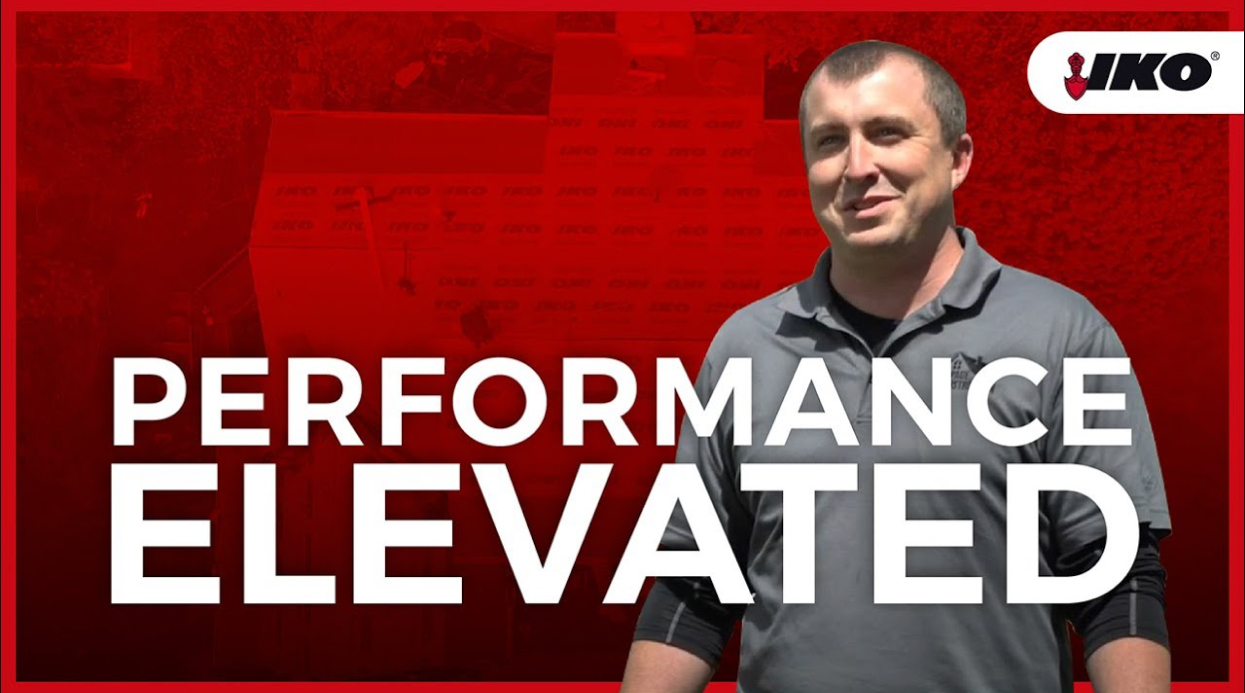 A man in a gray shirt stands against a red background, with "Performance Elevated" boldly displayed alongside the IKO logo. Proudly associated with DuPage Construction, the scene subtly hints at quality roofing solutions that elevate standards.