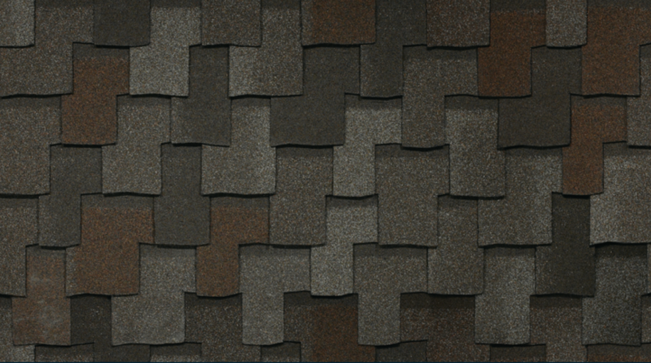 Armourshake shingles in Chalet Wood offer a sophisticated blend of dark gray and brown, arranged in an overlapping pattern that enhances the roof's texture. Experience the elegance of IKO Roof Shingle Colors with this durable choice.