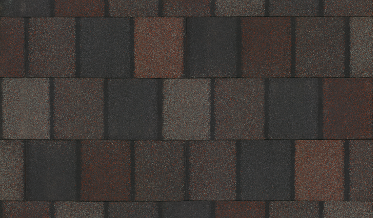 A close-up view of overlapping asphalt roof shingles in alternating dark brown and black shades, reminiscent of the elegant Crowne Slate finish.