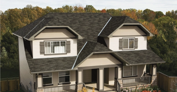 This charming two-story house features a dark roof and beige siding, complemented by a front porch perfect for relaxing after a Marathon run. It’s nestled behind a wooden fence, with trees providing a scenic backdrop on a clear day.