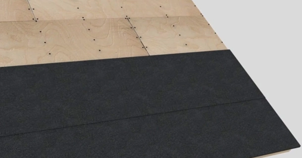 A wooden roof structure features three overlapping plywood panels, partially covered by a layer of Roof-Fast material, ideal for low slope designs.