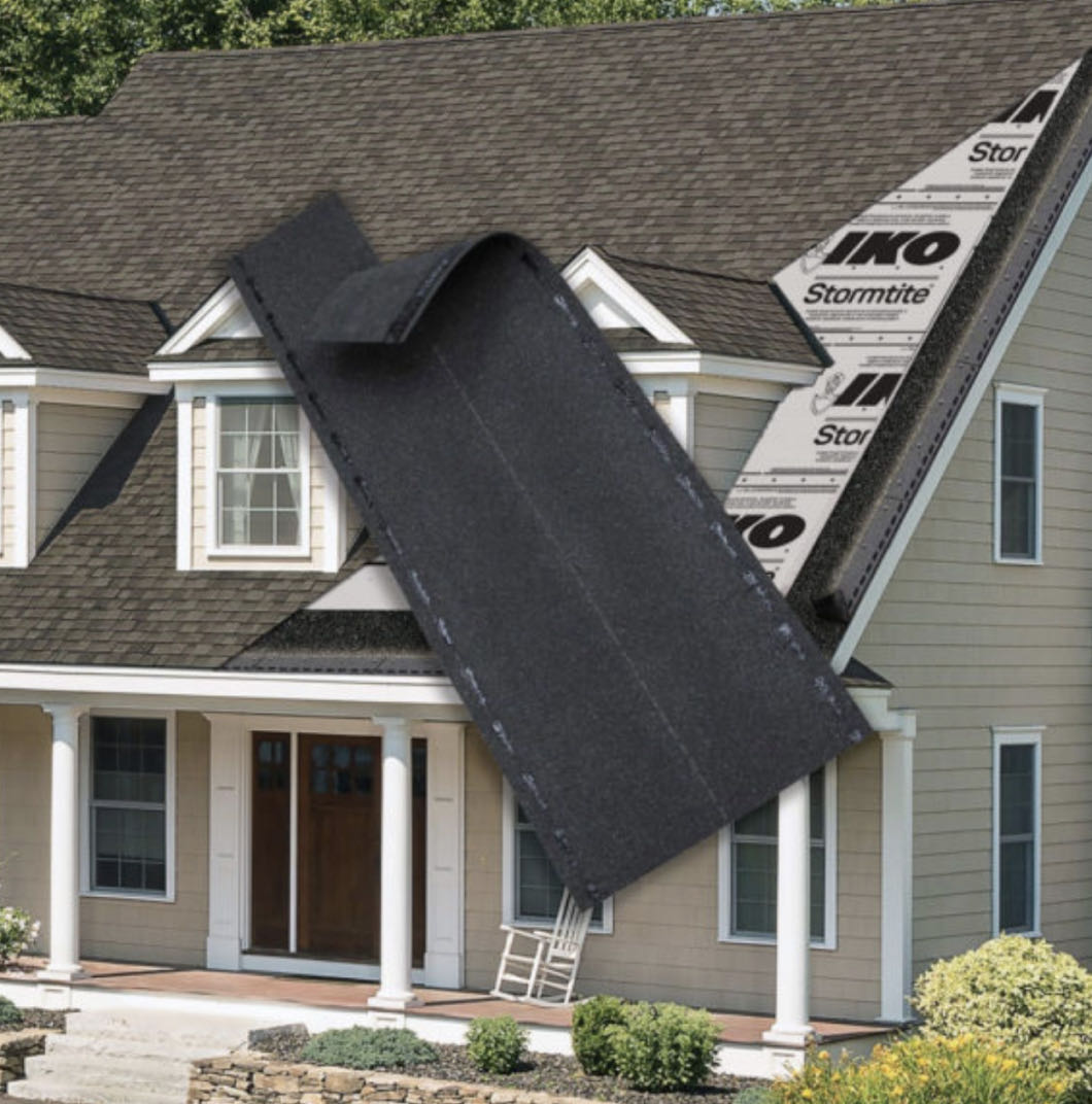 A large roofing shingle is digitally superimposed over a house, showcasing Leading Edge Plus™ roofing installation. A ladder is propped against the house.