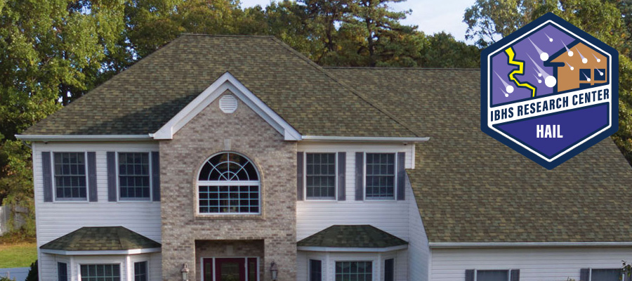 A two-story house with a large roof and brick facade. The IBHS Research Center Hail logo is displayed in the top right corner.