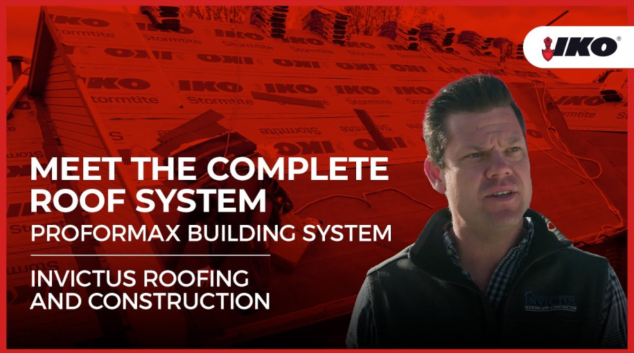 A man stands before a roof under construction, proudly showcasing the "Meet the Complete Roof System" with PROFORMAX Building System and Invictus Roofing logos on display.