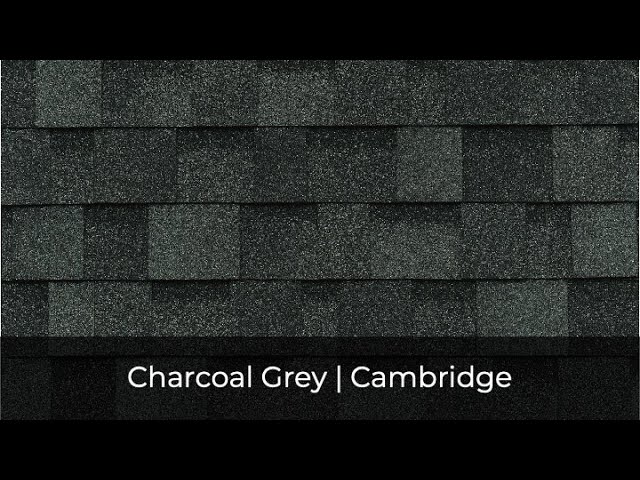 The dark grey roof shingles boast a textured pattern, perfectly encapsulated by the name "Cambridge Charcoal Grey," part of the IKO Roof Shingle Colors collection.